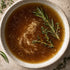 close up shot of beef bone broth in ceramic bowl