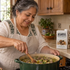 woman cooking with accomplice bison flavored bone broth at kitchen stove